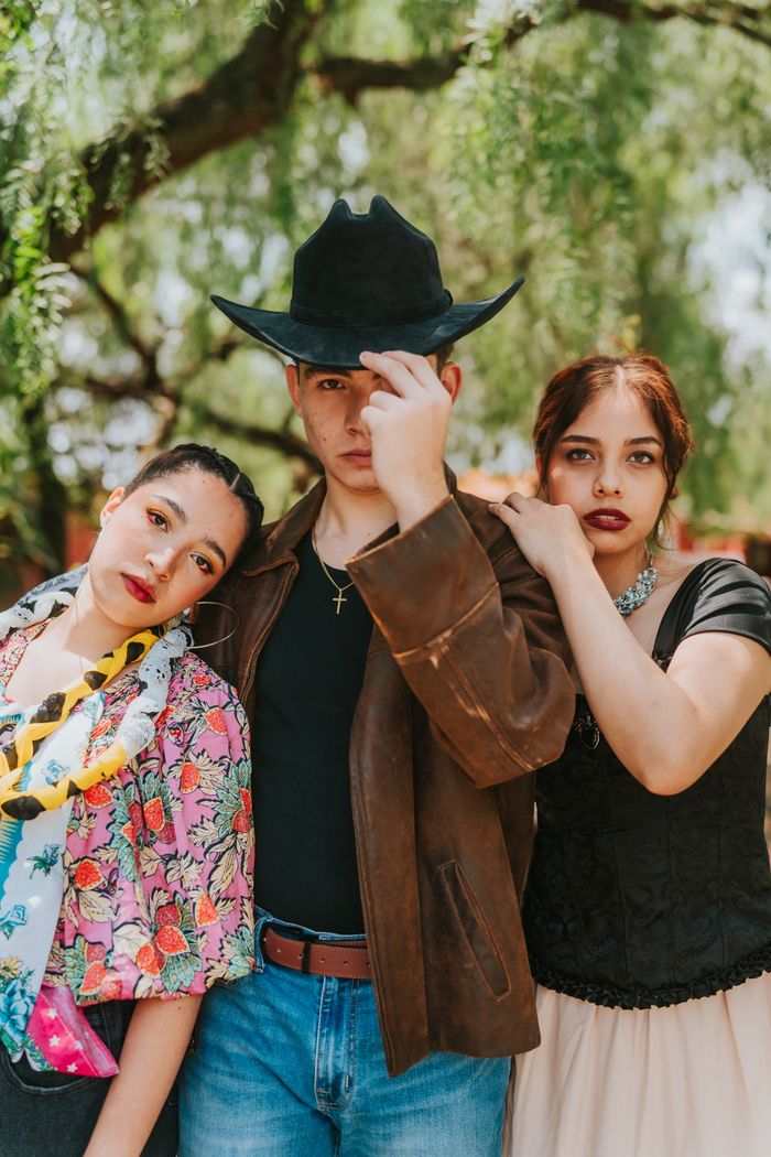 Stylish group posing in vintage fashion outdoors.